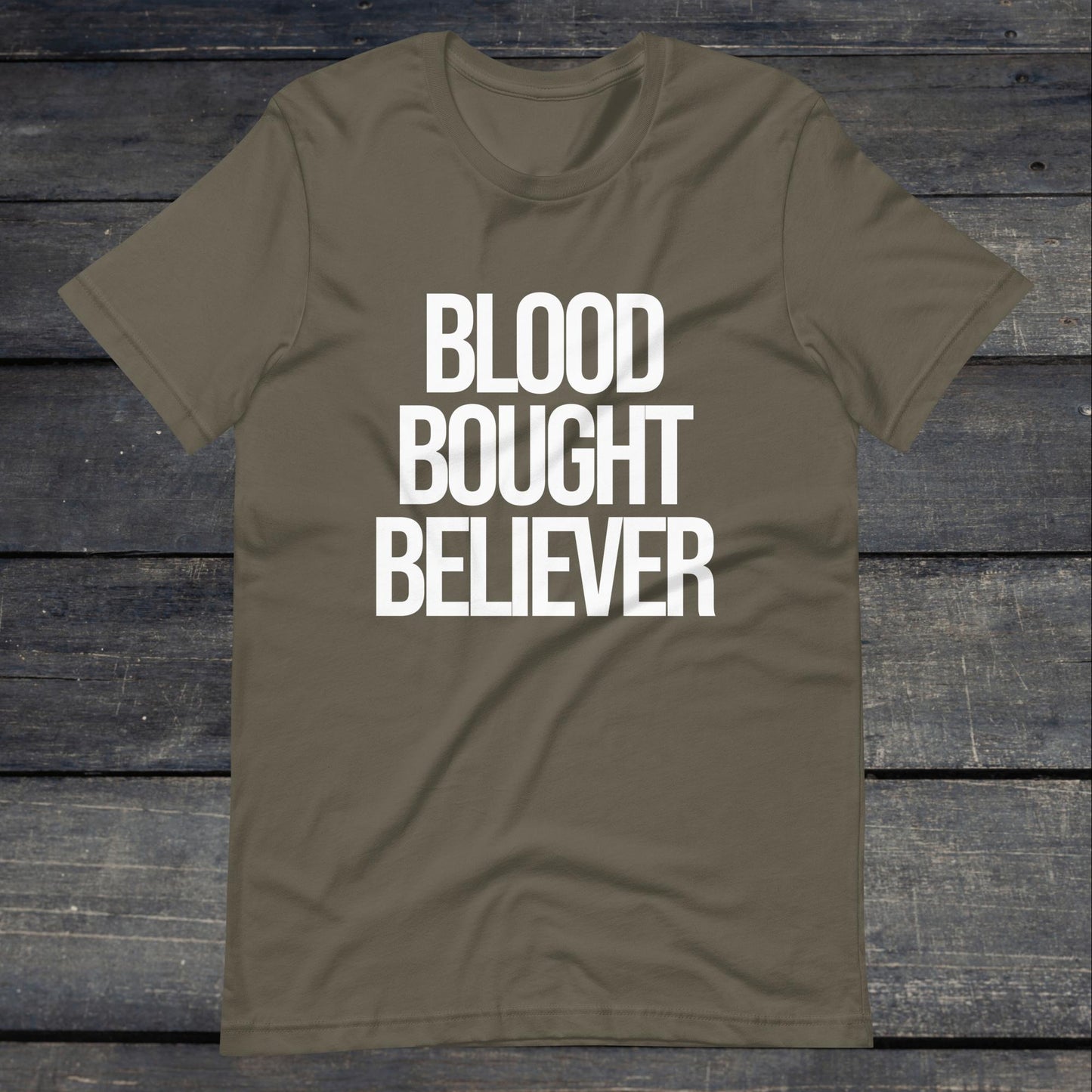 A photo of the Blood Bought Believer Tee. This tee is army green with white text that reads blood bought believer.