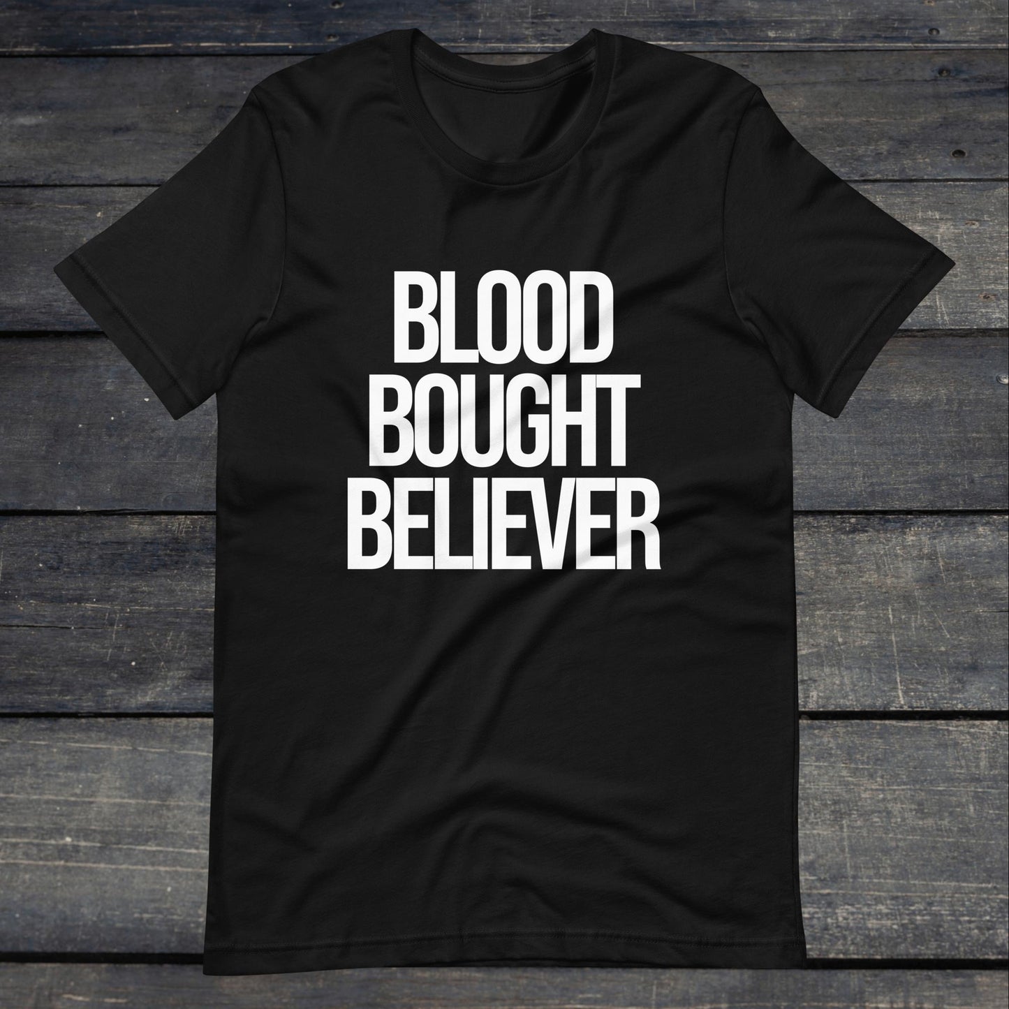 A photo of the Blood Bought Believer Tee. This tee is black with white text that reads Blood Bought Believer in large bold lettering.