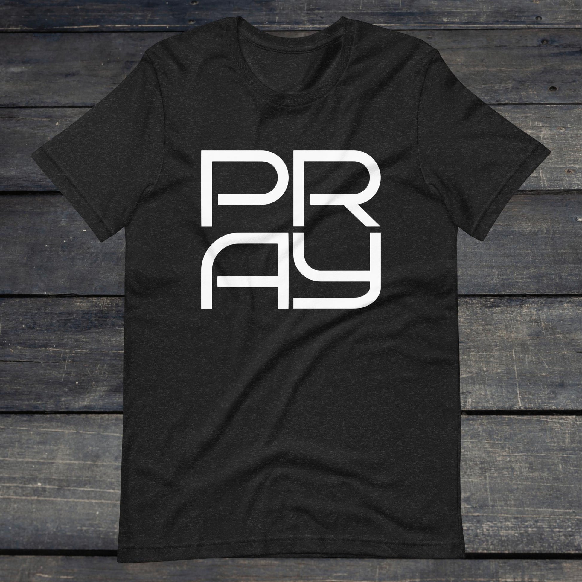 A photo of the Pray 4 Tee. This tee is heather grey with white text that reads P-R-A-Y in large stylish lettering.