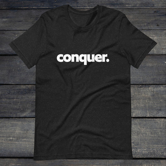 A photo of the Conquer Tee. This tee is heather grey with white text that reads conquer in large bold lettering.